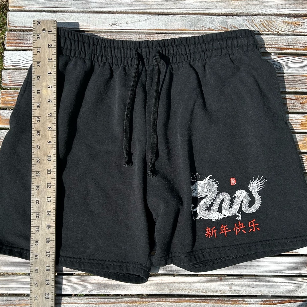 Black shorts with dragon design.
